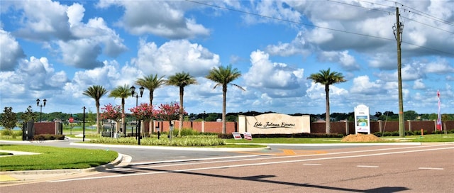 view of road featuring curbs and traffic signs