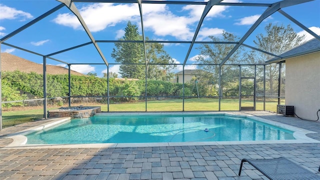 view of swimming pool with a yard, a patio area, an in ground hot tub, and glass enclosure