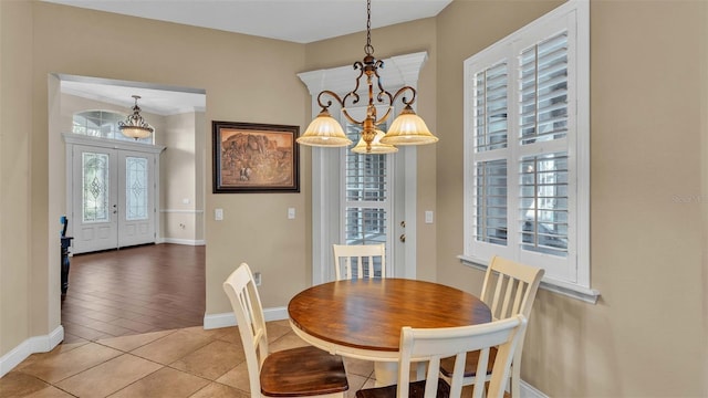 dining room featuring an inviting chandelier, hardwood / wood-style floors, and french doors