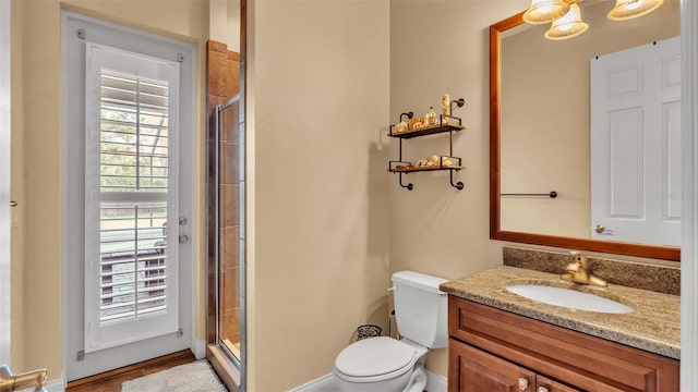 bathroom with vanity, toilet, and an enclosed shower