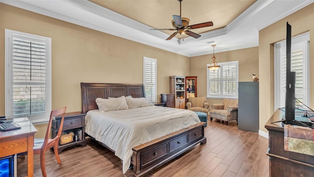 bedroom with multiple windows, ornamental molding, hardwood / wood-style flooring, and ceiling fan