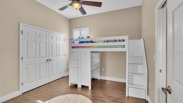 bedroom featuring hardwood / wood-style floors, a closet, and ceiling fan