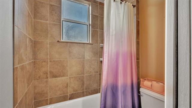 bathroom with toilet and shower / bath combo with shower curtain