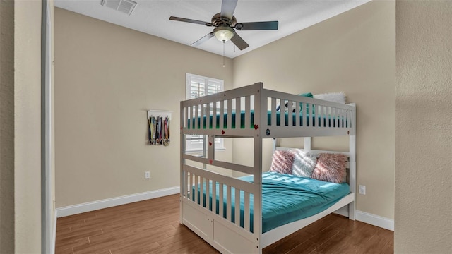 bedroom with hardwood / wood-style flooring and ceiling fan