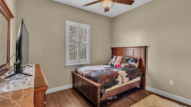 bedroom with dark hardwood / wood-style floors and ceiling fan