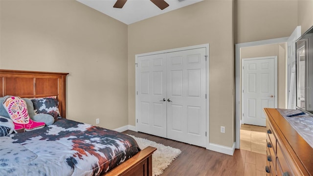 bedroom featuring a closet, dark wood-type flooring, and ceiling fan