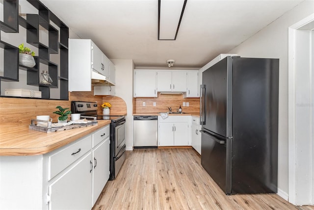 kitchen with light hardwood / wood-style flooring, white cabinets, black appliances, and backsplash