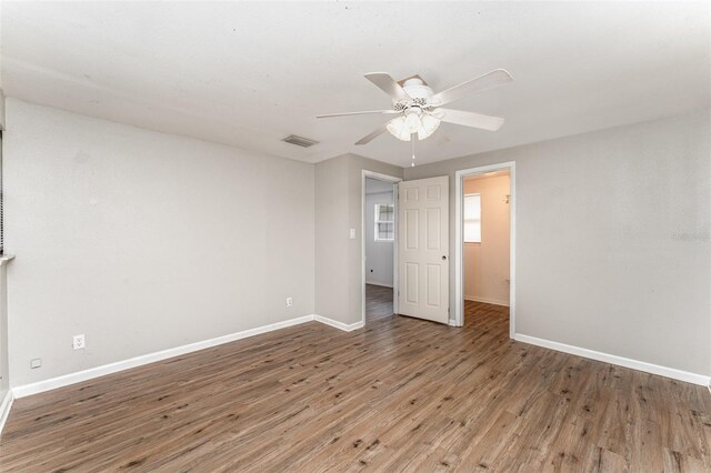 unfurnished bedroom featuring ceiling fan and dark hardwood / wood-style floors