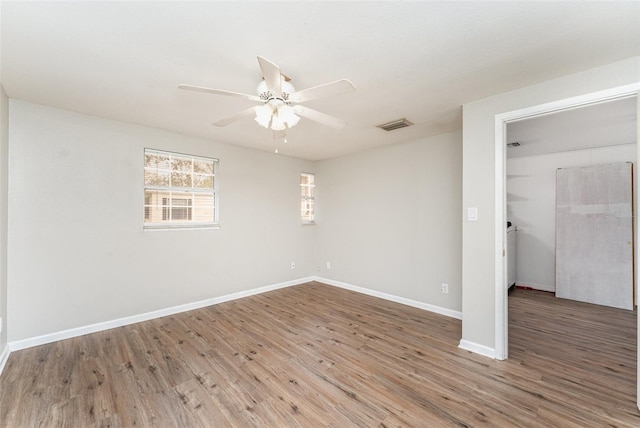 spare room with wood-type flooring and ceiling fan