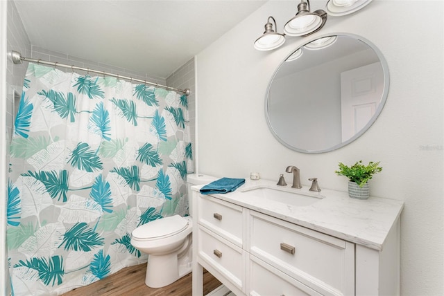 bathroom featuring vanity, toilet, hardwood / wood-style flooring, and a shower with shower curtain