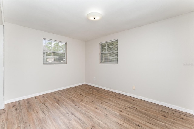 empty room with light hardwood / wood-style flooring