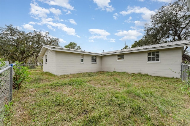 rear view of property with a yard