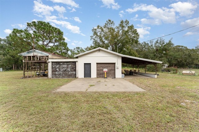 garage featuring a yard and a carport