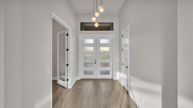 entryway featuring french doors and light wood-type flooring