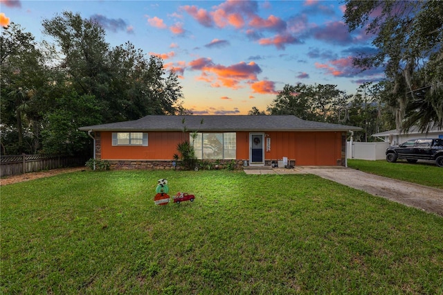 ranch-style home with a lawn