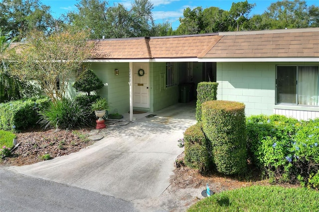 view of exterior entry with a carport