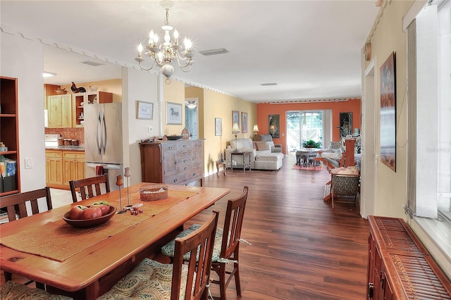 dining space with a chandelier and dark wood-type flooring