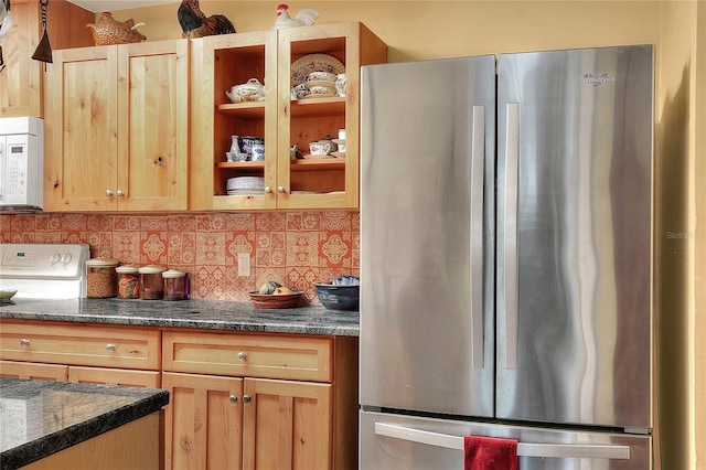 kitchen featuring decorative backsplash and white appliances