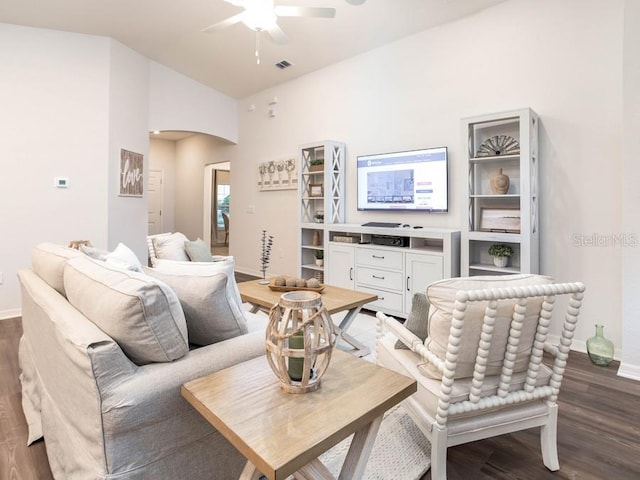 living room featuring ceiling fan, hardwood / wood-style flooring, and vaulted ceiling