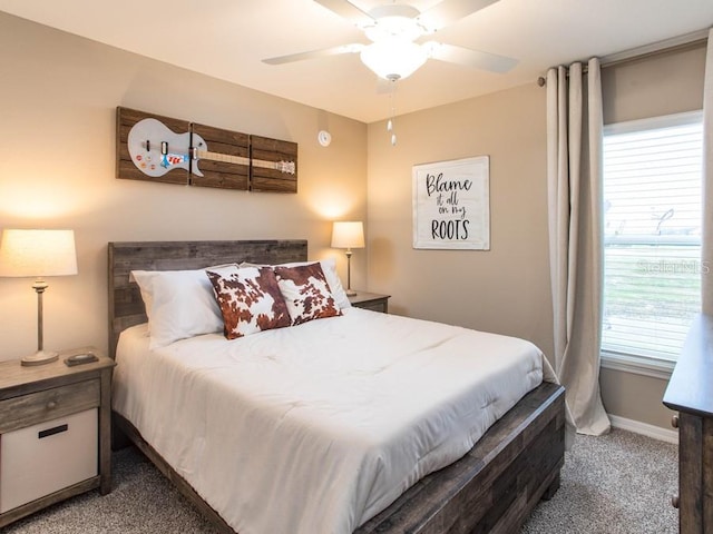 bedroom with ceiling fan and dark colored carpet