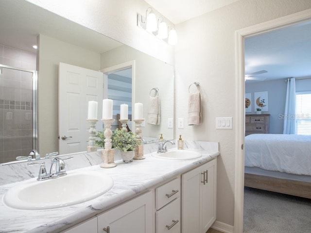 bathroom with vanity, ceiling fan, and an enclosed shower