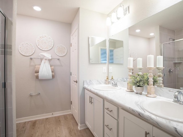 bathroom featuring vanity, hardwood / wood-style flooring, and walk in shower