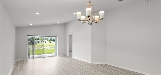 559 SW 77th Cir, Ocala, FL 34474 - spare room with light wood-type flooring, a chandelier, vaulted ceiling, baseboards, and recessed lighting