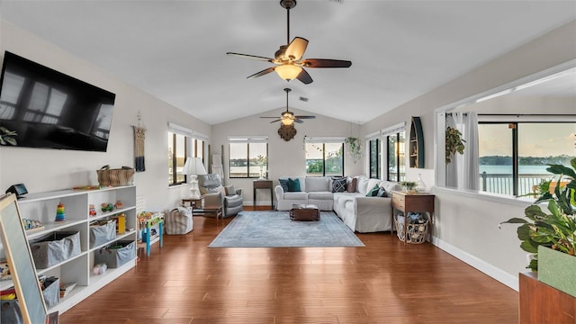 living room with ceiling fan, a water view, dark wood-type flooring, and lofted ceiling