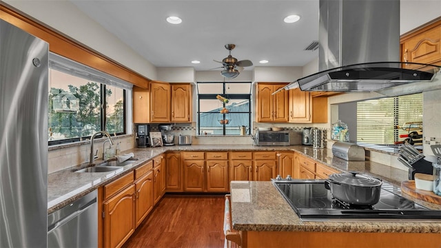 kitchen with ceiling fan, sink, dark wood-type flooring, island exhaust hood, and stainless steel appliances