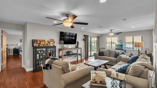 living room with dark hardwood / wood-style floors and ceiling fan