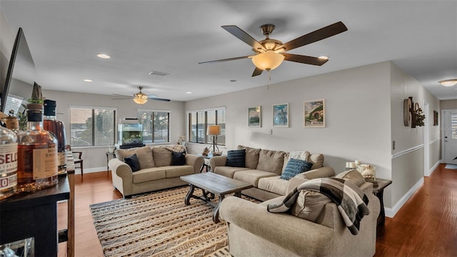 living area featuring recessed lighting, ceiling fan, baseboards, and wood finished floors