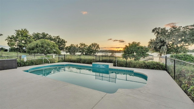 pool at dusk with a patio