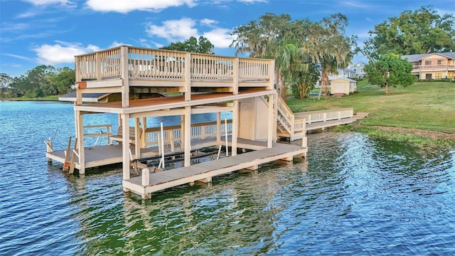 dock area featuring a water view, a yard, and boat lift