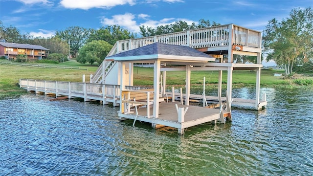 dock area with a lawn and a water view