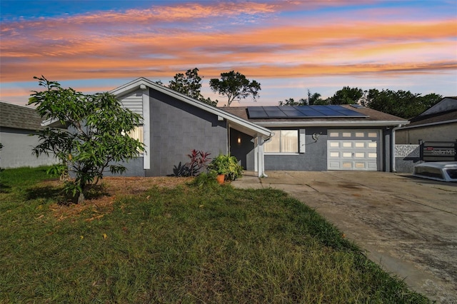 view of front of house featuring a lawn and solar panels