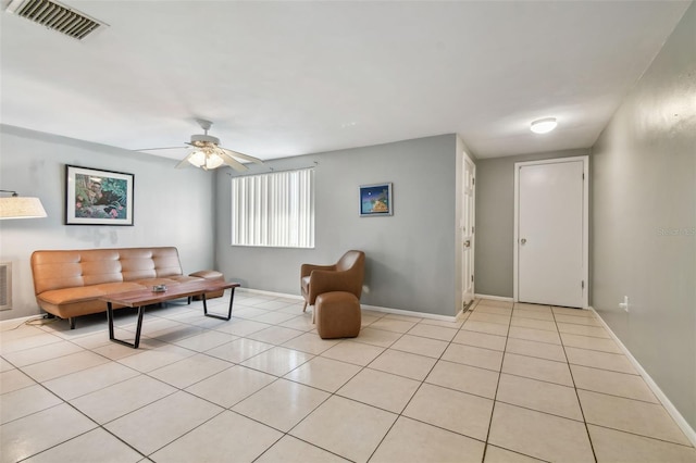 tiled living room featuring ceiling fan