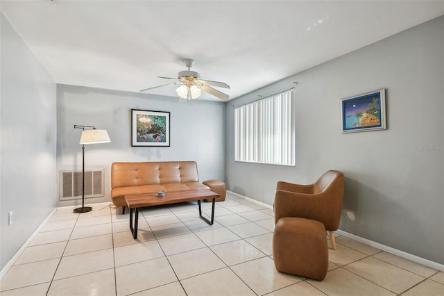 living area featuring light tile patterned floors and ceiling fan