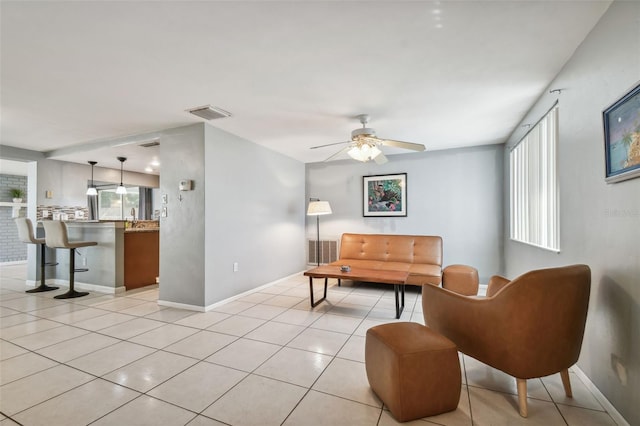 tiled living room featuring ceiling fan