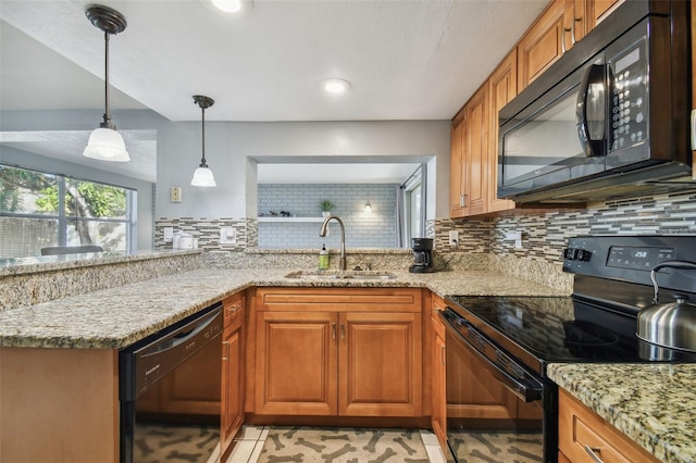 kitchen with black appliances, sink, light stone countertops, and tasteful backsplash