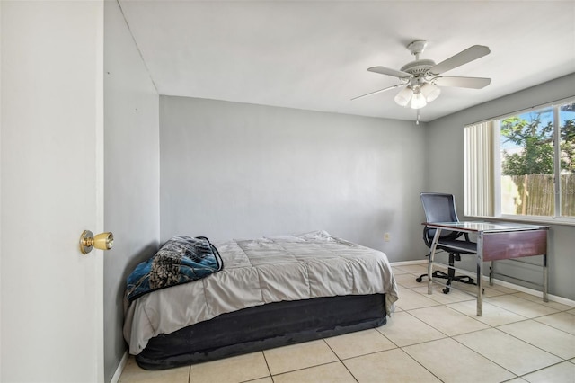 tiled bedroom featuring ceiling fan