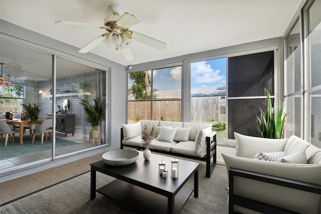 sunroom featuring ceiling fan