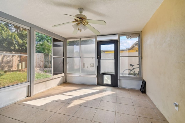 unfurnished sunroom with ceiling fan and a healthy amount of sunlight