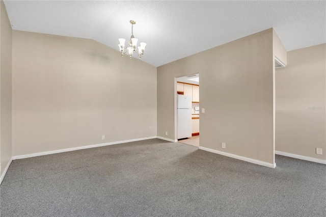 unfurnished room featuring an inviting chandelier, light colored carpet, and vaulted ceiling