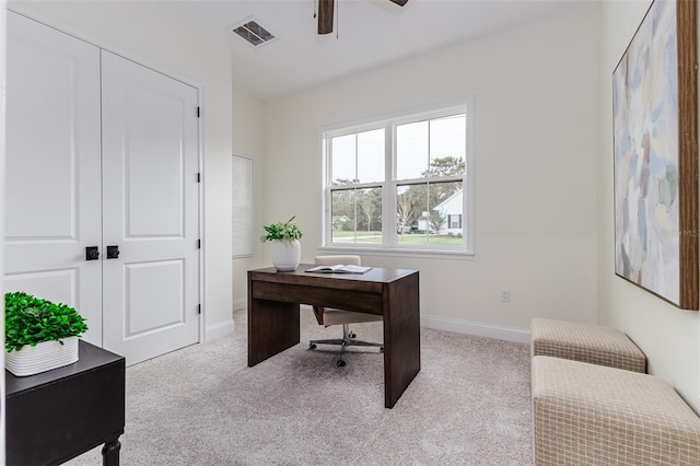 carpeted office space featuring ceiling fan