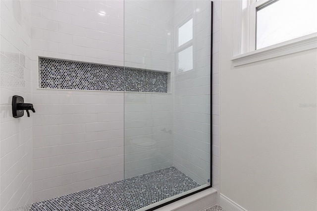 bathroom with tiled shower