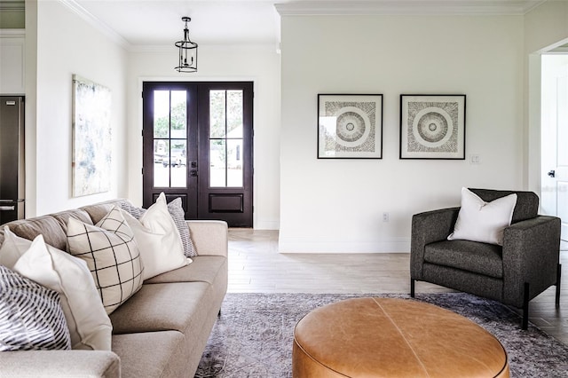 living room featuring french doors, hardwood / wood-style flooring, and ornamental molding