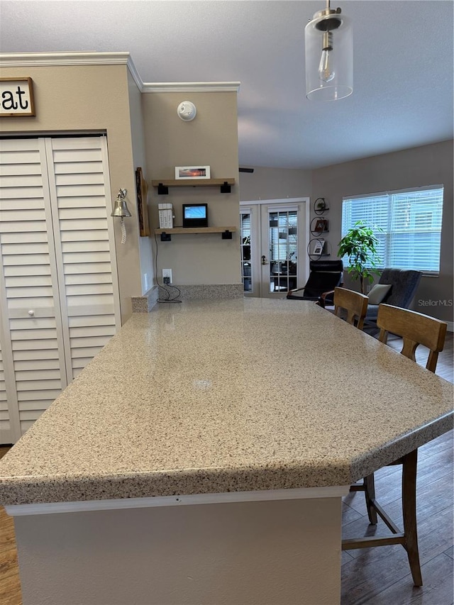 kitchen with a peninsula, hanging light fixtures, french doors, open shelves, and crown molding