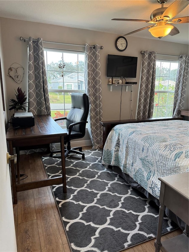 bedroom featuring hardwood / wood-style flooring and ceiling fan