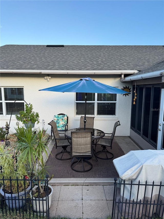 view of patio with fence and outdoor dining area