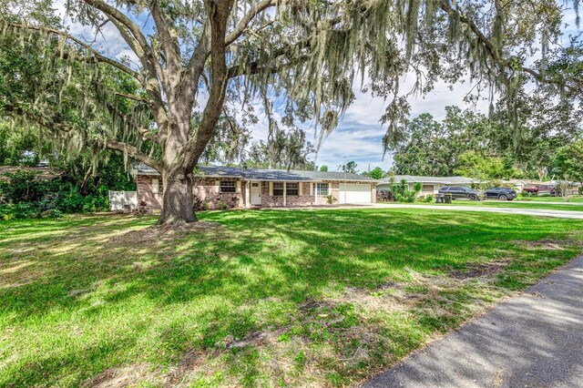 single story home with a front lawn and a garage